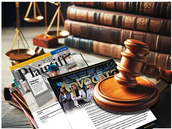 Law books, gavel with a stack of Plaintiff and Advocate magazines